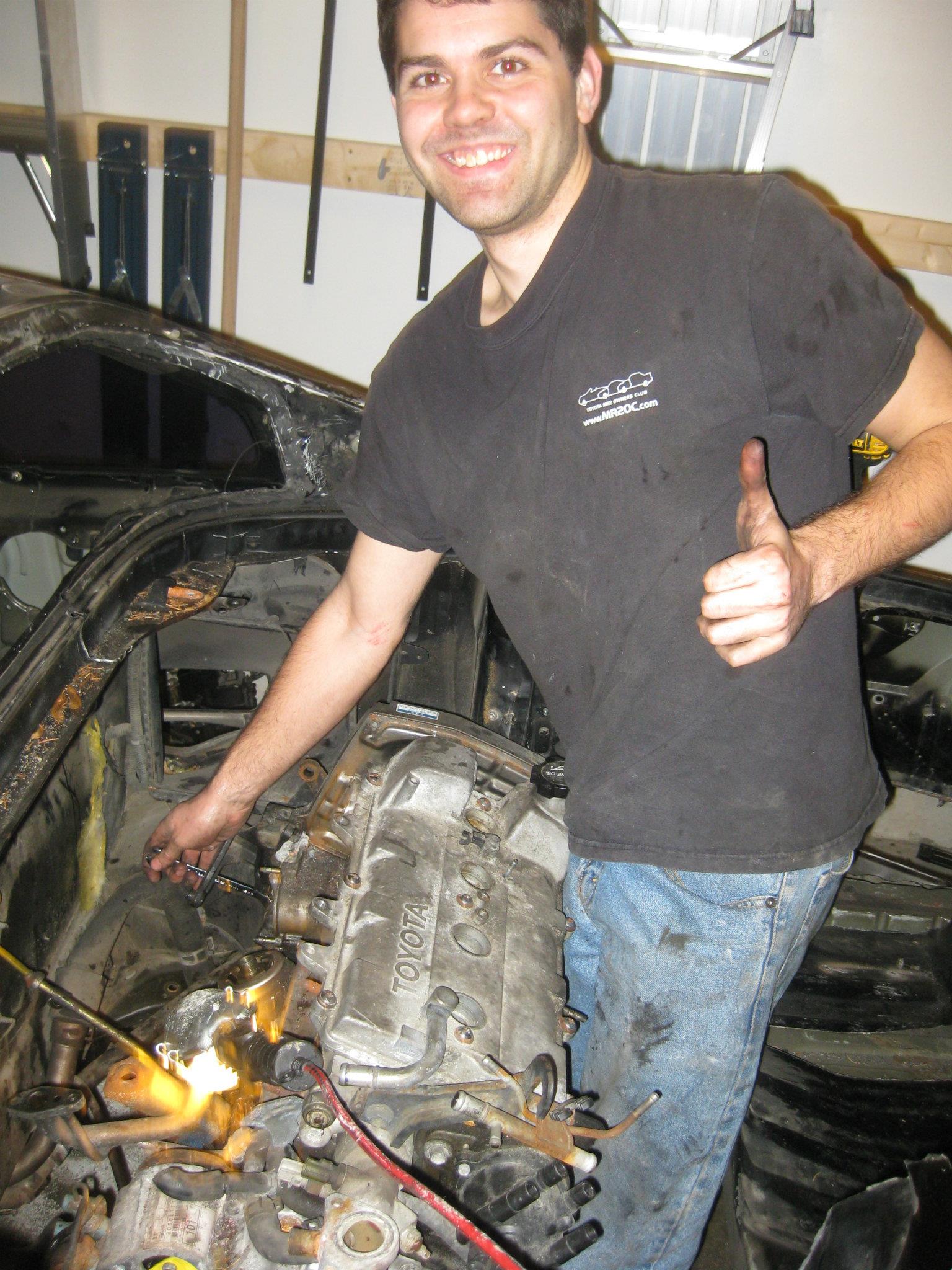 A picture of Bill working on a car